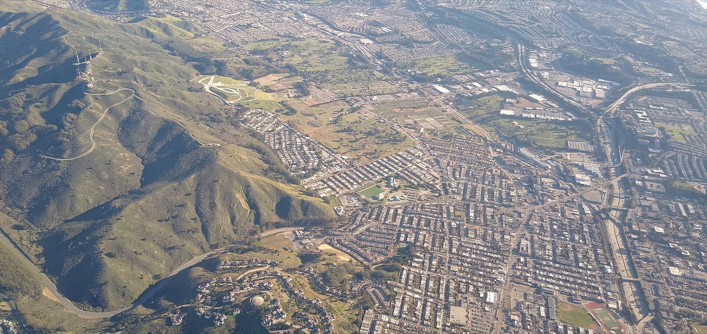 Aerial view of Daly City neighborhoods beside San Bruno Mountain